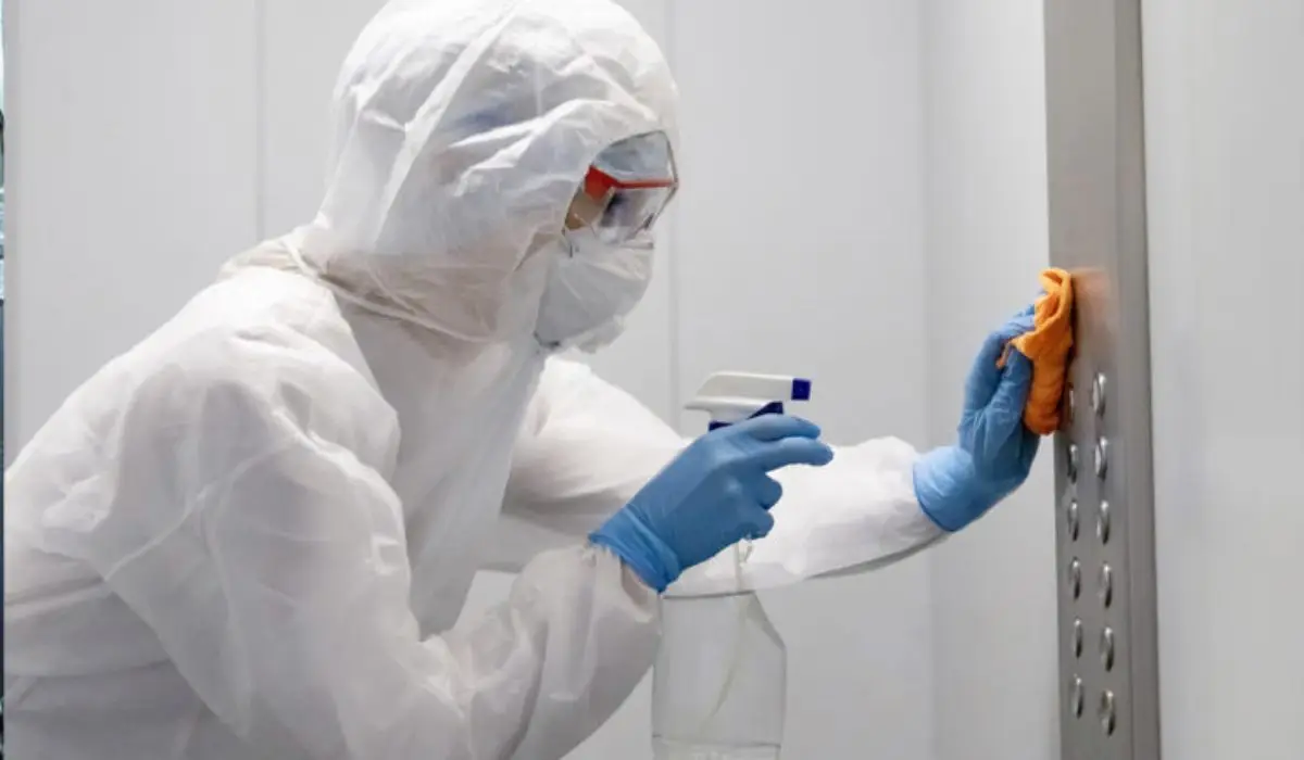 a professional commercial cleaner in a biochemical suit