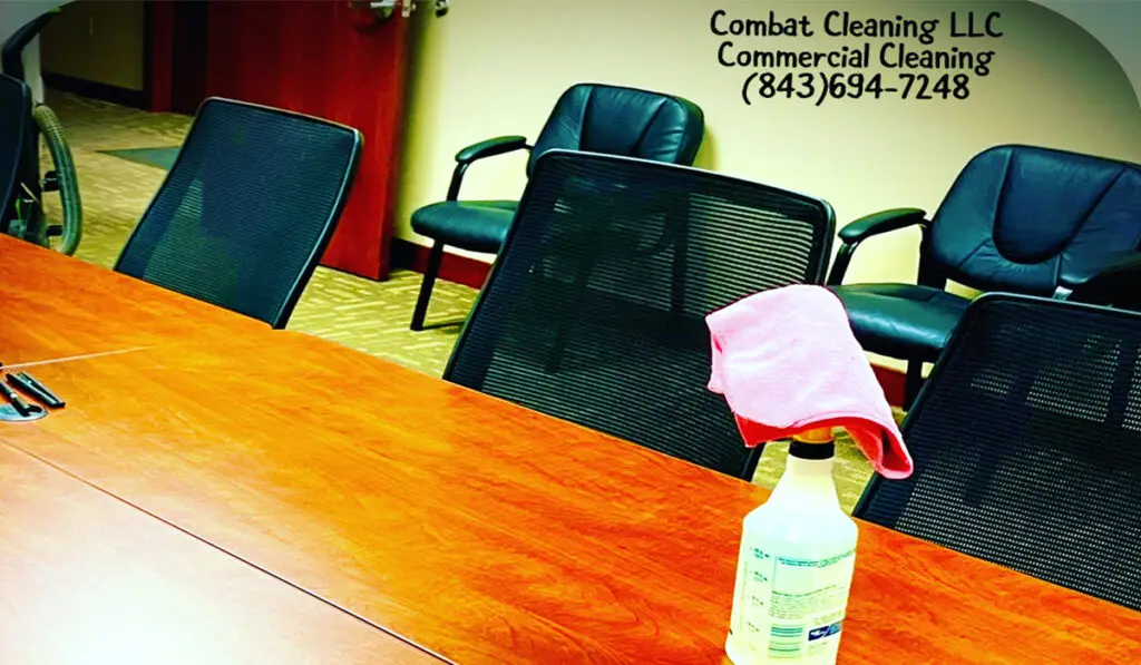 a cleaning spray bottle and microfiber on an office table